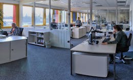 Picture from the MINDA office with people working at desks