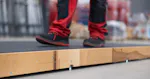 The photo shows a wooden conveyor belt for workers.