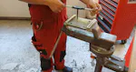 The photo shows a school student cutting a thread for the first time.