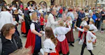 The photo shows the Cammer Traditional Costume Association during a performance.