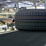 A close-up of a tire lying on a conveyor belt